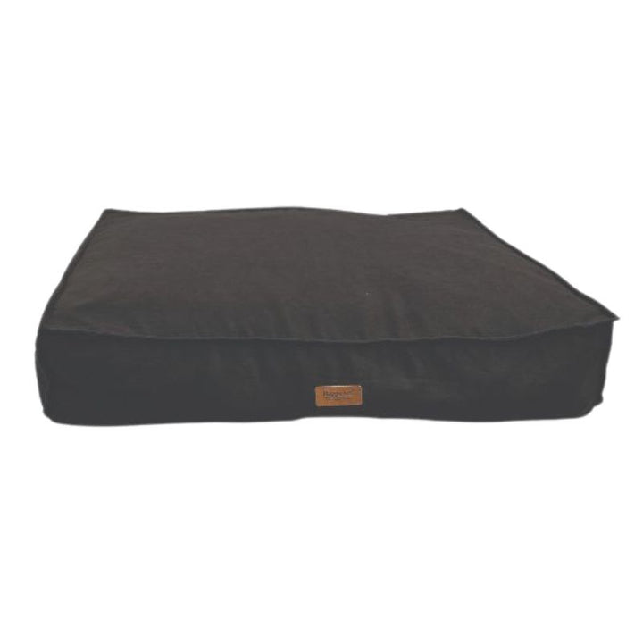 Black pet bed with a brand label on a white background