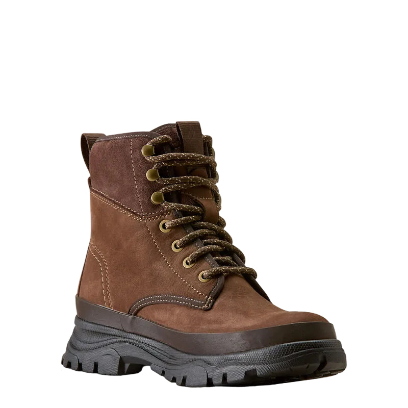 A brown suede lace-up ankle boot with a thick black lug sole, photographed on a clean off-white background.