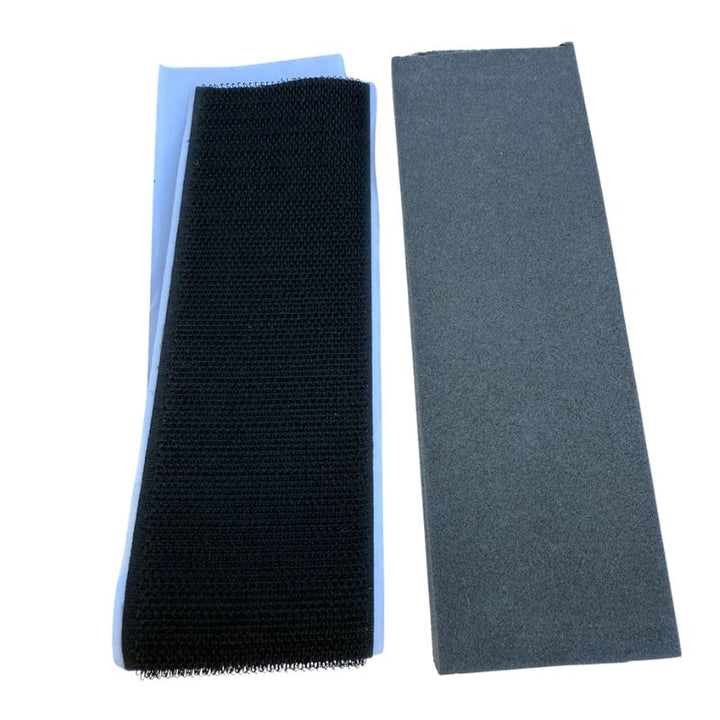 Three rectangular foam pads in black, blue, and gray on a white background