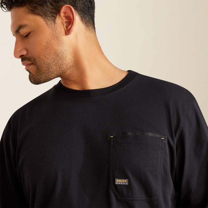 Man wearing a black Ariat shirt against a beige background