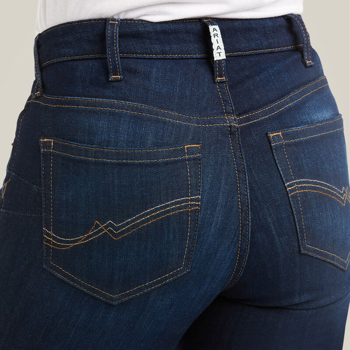 Ariat R.E.A.L. High Rise Ballary Boot Cut Jeans in Pennsylvania wash, rear close-up showing embroidered back pockets, Ariat waistband label and contrast stitching on dark blue denim.