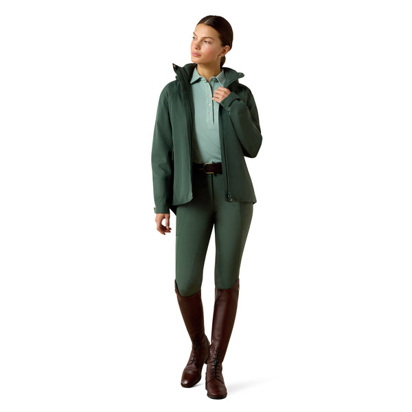 Woman wearing a green raincoat, pants, and boots on a white background