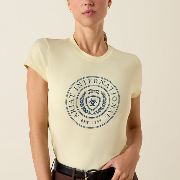 Person wearing a cream t-shirt with a blue logo and text on a beige background