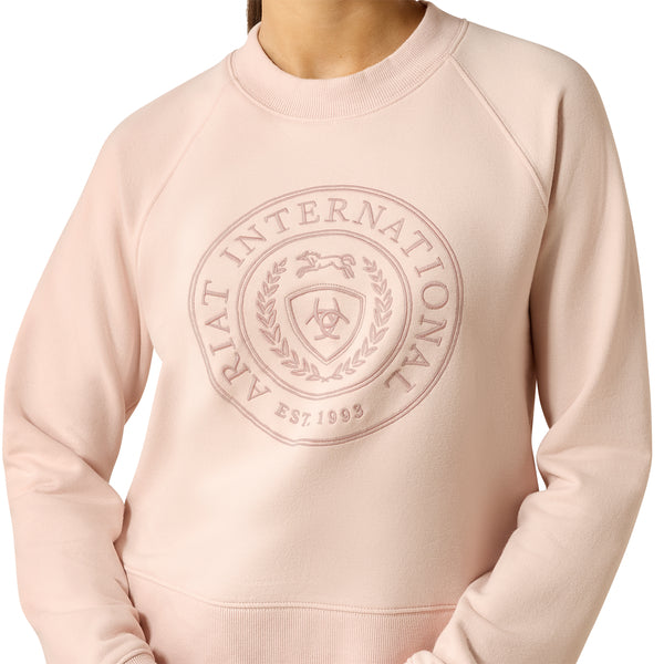 Pink sweatshirt with Ariat International logo on a white background