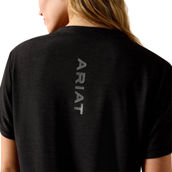 Person wearing a black Ariat t-shirt with the brand name on the back.