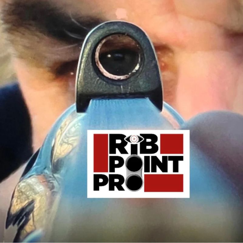 Close-up of a person aiming a rifle with 'Rib Point Pro' logo overlay.