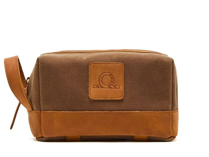 Brown toiletry bag with leather accents on a white background